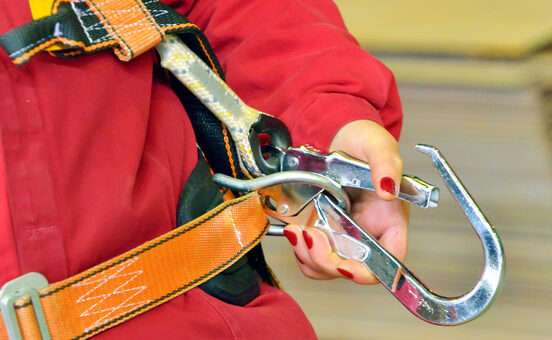 woman and a fall protection harness inside of factory