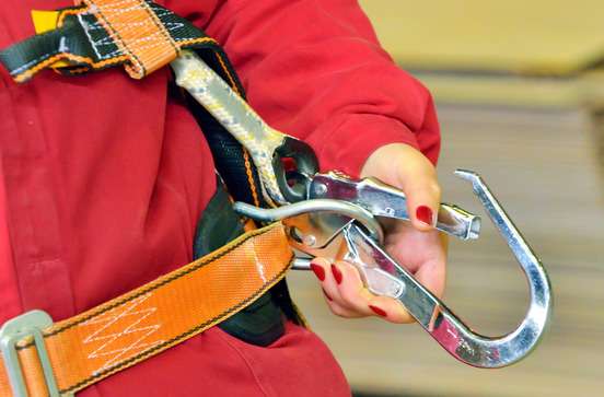 woman and a fall protection harness inside of factory