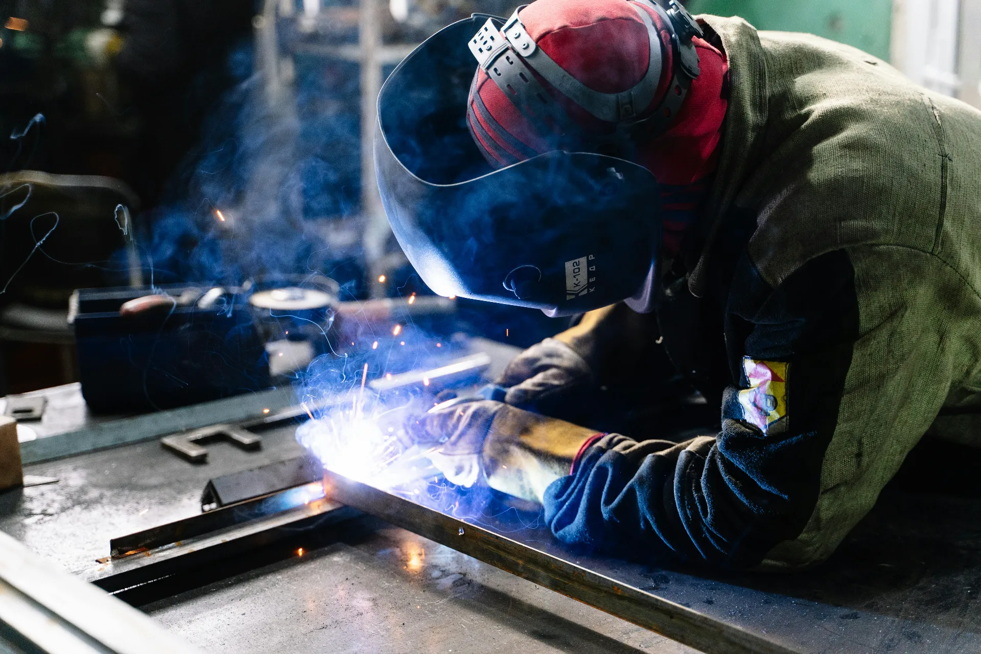 Person with construction safety certification welding metal